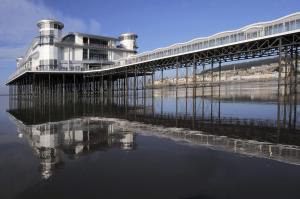 a pier with a building on top of the water at Bella Vista Hotel in Weston-super-Mare