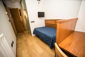 Postel nebo postele na pokoji v ubytování Hostal Caballeros