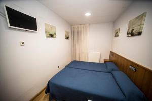 Postel nebo postele na pokoji v ubytování Hostal Caballeros