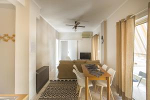 a small apartment with a dining table and a bedroom at Francis Getaway in Pireaus in Piraeus