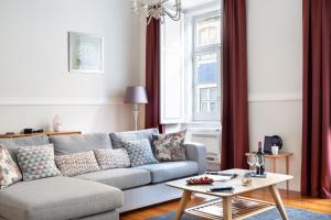a living room with a couch and a table at JOIVY Downtown City Apartments in Lisbon