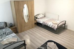 a small bedroom with a bed and a mirror at Relax Apartment Grossbettlingen in Großbettlingen