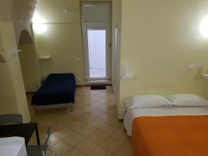 a hotel room with a bed and a desk at Beda Ragusa in Ragusa