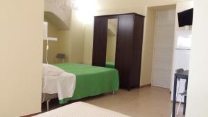 a room with a bed and a table at Beda Ragusa in Ragusa
