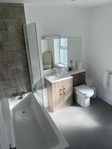 a bathroom with a sink, toilet and bathtub at Boars Head Hotel in Carmarthen