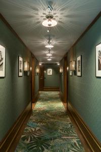 a hallway with green walls and a carpet at El Llorenc Parc de la Mar - Adults Only (+16) in Palma de Mallorca