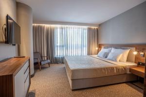Posteľ alebo postele v izbe v ubytovaní Hotel Tonanti