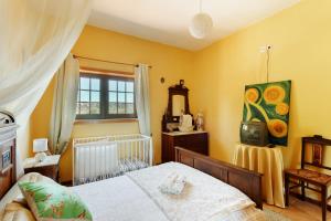 a bedroom with a bed and a tv in it at Casa do Casal in Guimarães +53 photos