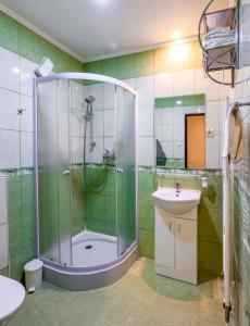 a bathroom with a shower and a sink at Penzión pod hradom Gelnica in Gelnica