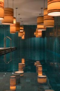 a bathroom with a bunch of toilets and lights at El Llorenc Parc de la Mar - Adults Only (+16) in Palma de Mallorca
