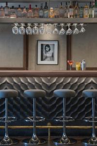 a bar with four bar stools in a room at El Llorenc Parc de la Mar - Adults Only (+16) in Palma de Mallorca