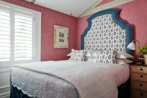 a bedroom with a large bed with pink walls at Number Sixteen, Firmdale Hotels in London