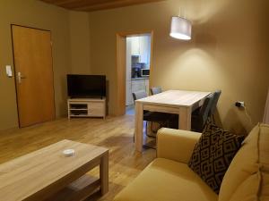 a living room with a couch and a table at Heester Apartments in Bunde