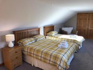 a bedroom with a bed and a lamp and a chair at Inveroran in Campbeltown