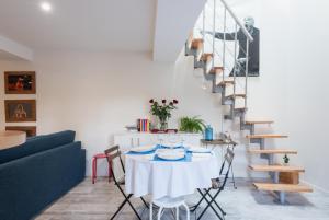 ein Esszimmer mit einem Tisch und einer Treppe in der Unterkunft Grand duplex au calme en centre-ville in Villefranche-sur-Saône