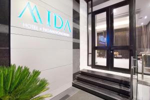a hotel with a sign on the side of a building at Mida Hotel Ngamwongwan - SHA Plus in Nonthaburi