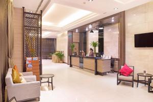 a lobby of a hotel with a reception desk at Mida Hotel Ngamwongwan - SHA Plus in Nonthaburi