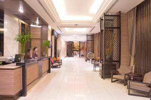 a lobby of a restaurant with people sitting at a counter at Mida Hotel Ngamwongwan - SHA Plus in Nonthaburi
