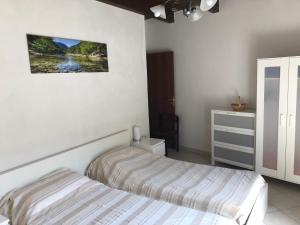 a bedroom with two beds and a dresser at Casa Vacanze BELLO in Pietraroia
