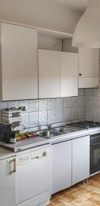 a kitchen with white cabinets and a sink at RICCI Rooms in Roccasecca +42 photos