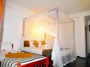 Letto o letti in una camera di Shanika Beach Inn