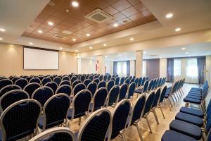 a conference room with chairs and a screen at Eurostars Málaga in Málaga