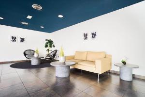 a living room with a couch and two tables at Eurostars Málaga in Málaga