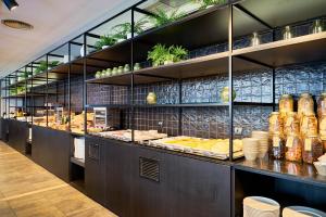 a kitchen with a buffet line with food on display at Eurostars Málaga in Málaga