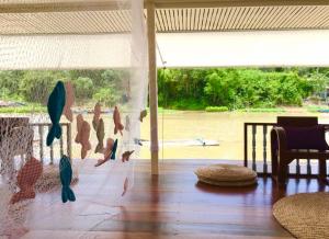 a living room with a wall with birds on it at อยู่แพ PaeStay อุทัยธานี in Uthai Thani