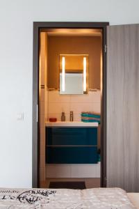 a bathroom with a sink and a mirror at Romantica in Rust +25 photos