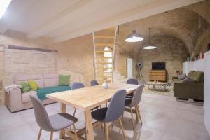ein Wohnzimmer mit einem Holztisch und Stühlen in der Unterkunft Casa petra in Bari