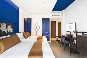 Postel nebo postele na pokoji v ubytování Aksorn Rayong, The Vitality Collection - SHA PLUS