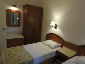 a small bedroom with a bed and a mirror at Musti Apart Hotel in Alanya +108 photos