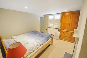 a small bedroom with a bed and a window at Best located and beautifully renovated cottage in Diss