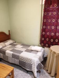 a small bedroom with two beds and a table at Hostal la Horra in La Horra +9 photos