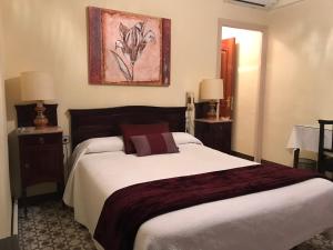 a bedroom with a large bed and two lamps at Hotel Suís in Sant Celoni +99 photos
