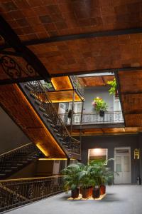 eine Treppe in einem Gebäude mit Topfpflanzen in der Unterkunft Hotel Principal in Mexiko-Stadt