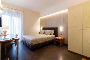 Postel nebo postele na pokoji v ubytování Il Melograno Relais + 35 fotografií