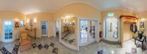 a large room with a hallway with mirrors and a room with at Hotel Villa im Park in Düsseldorf