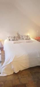 a white bed with white sheets and pillows on it at Carré Saint-Gervais Rouen centre in Rouen