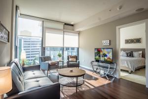a living room with a couch and a tv at Atlanta Furnished Apartments - Great location in the Heart of the City in Atlanta
