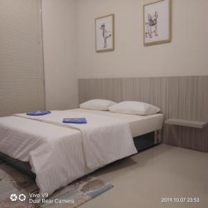 a bedroom with a bed with white sheets and pillows at SleepRest @ The Home Shoutlink in Nagoya