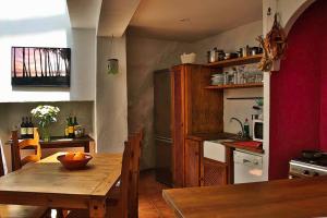 a kitchen with a wooden table with a bowl of fruit on it at Casa Amado in Olvera