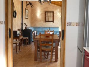 a dining room with a table and chairs at El Carro del Abuelo in Villovela de Pirón