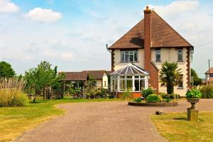 a large house with a pathway in front of it at Elmcroft Guest House in Epping