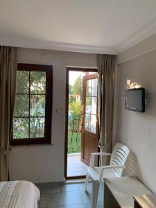 A television and/or entertainment centre at Olympos Hotel - Adults Only