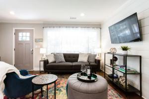 a living room with a couch and a tv at Lavish Living - 8 mins from Braves Stadium w/King in Smyrna