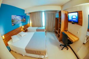 En eller flere senge i et værelse på Tri Hotel Smart Criciuma