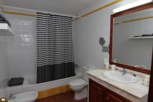 a bathroom with a toilet and a shower curtain at Apartamento Casa Francis in Breña Baja