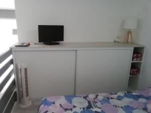 a desk with a computer monitor on top of it at Marendes Des Palombes 2 in Le Barcarès